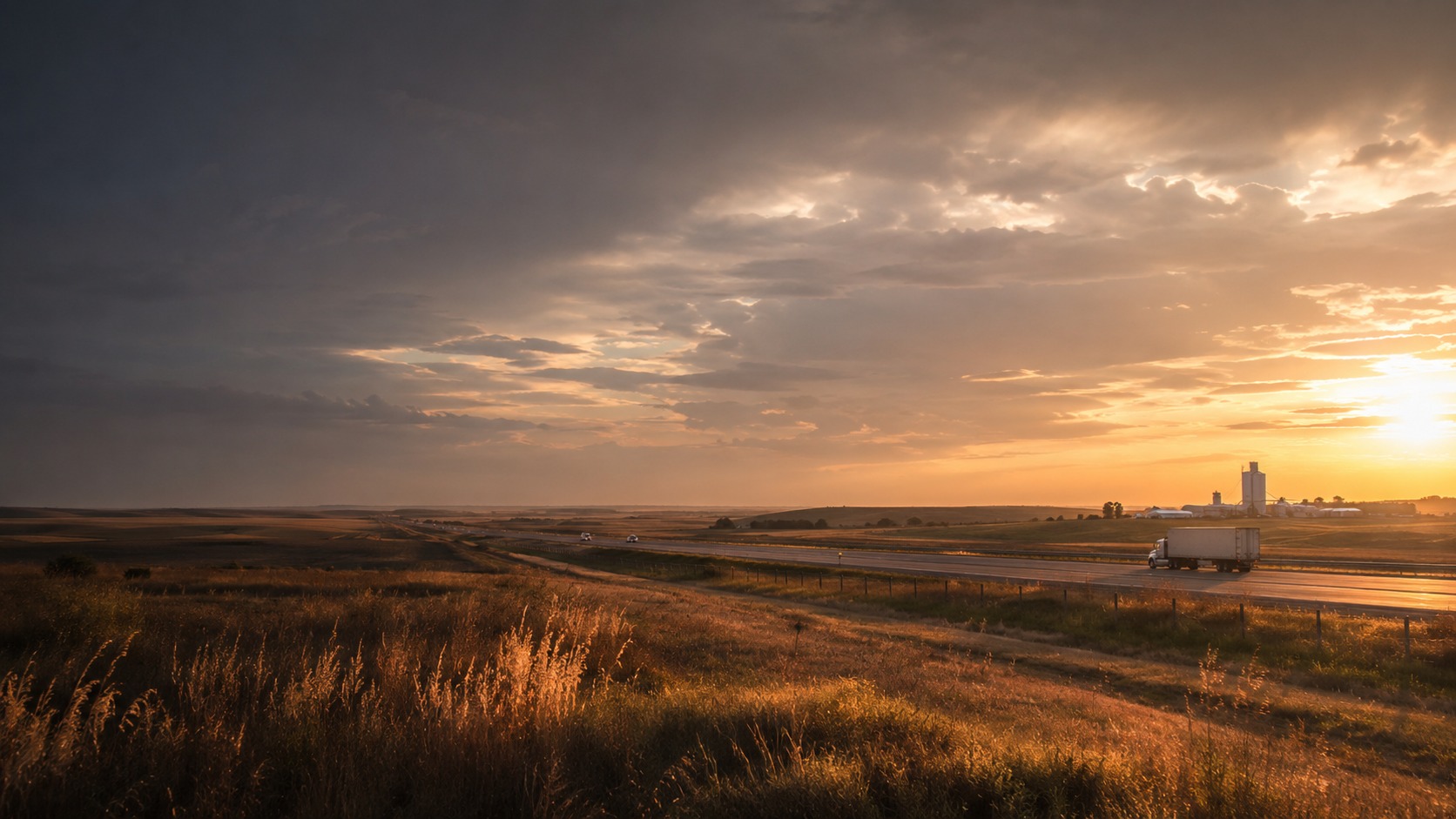 Western Kansas prairie and highway near Hays at golden hour